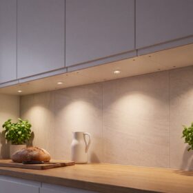 HiluX D1 Gen3 white recessed spotlights under kitchen wall cabinets, washing the stone backsplash and oak worktop in warm light